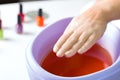 Woman in nail salon having paraffin bath