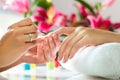 Woman in nail salon receiving manicure Royalty Free Stock Photo