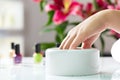 Woman in nail salon receiving manicure