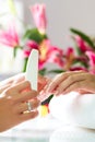 Woman in nail salon receiving manicure