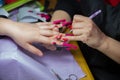 Woman in a nail salon receiving a manicure by a beautician . Manicure process in beautiful salon . Closeup of Woman applying nail Royalty Free Stock Photo