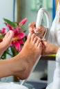 Woman in nail studio receiving pedicure Royalty Free Stock Photo