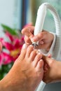 Woman in nail studio receiving pedicure Royalty Free Stock Photo