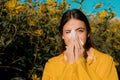 Woman with napkin fighting blossom allergie outdoor. Attractive girl outdoor with tissue having allergy. Young female is