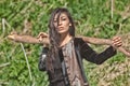 Woman in national black velvet dress with a stick in his hand and expressive eyes on nature background Royalty Free Stock Photo