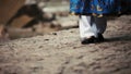 Woman in national Caucasian suit goes along stream