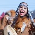 Woman in national clothing indigenous inhabitants Kamchatka dancing with tambourine. Concert, celebration Koryak