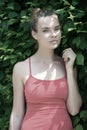 Woman with natural makeup in prague, czech republic on sunny day. Sensual woman on green fence. Girl with young look and