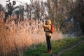 Woman naturalist is watching birds with binoculars