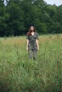 Woman on nature standing in a field tall grass Royalty Free Stock Photo