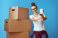 Woman near cardboard box using with tape dispenser as a gun Royalty Free Stock Photo