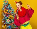 Woman near Christmas tree with microphone singing Royalty Free Stock Photo