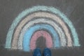 Woman near rainbow drawn with chalk on asphalt, above view