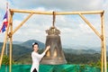 Woman near Thai gong in Phuket. Tradition asian bell in Buddhism temple in Thailand. Famous Big bell wish near Gold Buddha Royalty Free Stock Photo