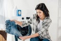 woman near washer holding kid jeans Royalty Free Stock Photo