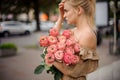 Woman neatly holds in her hand bouquet of stylish bright peony roses Royalty Free Stock Photo