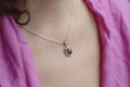 Woman neckline wearing moon stone mineral stone pendant on silver chain