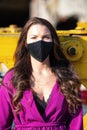 Woman with neckline wearing trendy black fashion face mask due coronavirus Covid-19 protection