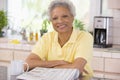 Woman with a newspaper smiling