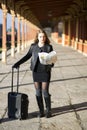 Woman next to baggage look route map