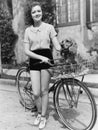 Woman next to her bicycle with her dog in the basket Royalty Free Stock Photo