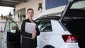 Woman next to white Mercedesbenz cclass in car showroom