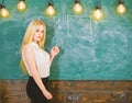 Woman with nice buttocks teaching mathematics. teacher concept. Lady teacher with long hair explaining formula Royalty Free Stock Photo