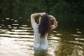 Woman in nightie is bathing in the river Royalty Free Stock Photo