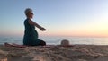 Woman in ninth month of pregnancy excercising on beach