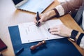 Woman notary signing last will and testament, closeup Royalty Free Stock Photo