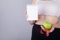 Woman, notepad, tape measure and green apple Royalty Free Stock Photo