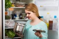 Woman noticed foul smell of food from casserole Royalty Free Stock Photo