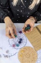 Woman numerologist astrologer counts numbers. Selective focus