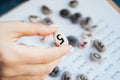 Woman numerologist hand with pebble stone with number five 5. Royalty Free Stock Photo