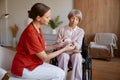 Woman nurse caregiver giving pills to old woman for healthcare support Royalty Free Stock Photo
