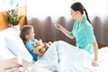 Woman nurse checking temperature of sick little girl Royalty Free Stock Photo