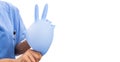 Woman nurse holding inflated surgical glove making peace gestur