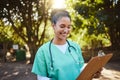 Woman, nurse and smile looking at clipboard in healthcare, medical or prescription in outdoor park. Happy female doctor Royalty Free Stock Photo