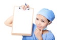 Woman nurse thinking showing clipboard Royalty Free Stock Photo