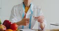 Woman nutritionist or dietician doctor healthy lifestyle concept - holding a glass of water. Healthy nutrition, eco food