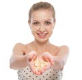 Woman with oatmeal facial mask showing oatmeal