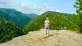 A woman observes the beautiful nature. A view of the most beautiful mountains in a panoramic scene. View from Tomasovsky