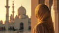 woman observing mosque at sunset