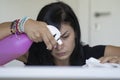 Woman with obsessive compulsive disorder cleaning table with detergents. OCD concept