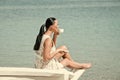 Woman at the ocean drinks coffee. Sea or ocean and drinking woman.