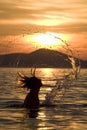 Woman in ocean at sunset Royalty Free Stock Photo