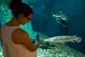 Woman in the oceanarium near alligator gar fish Royalty Free Stock Photo