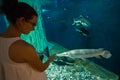 Woman in the oceanarium near alligator gar fish Royalty Free Stock Photo