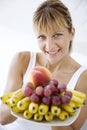 Woman offering fruit Royalty Free Stock Photo