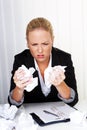 Woman in office with crumpled paper